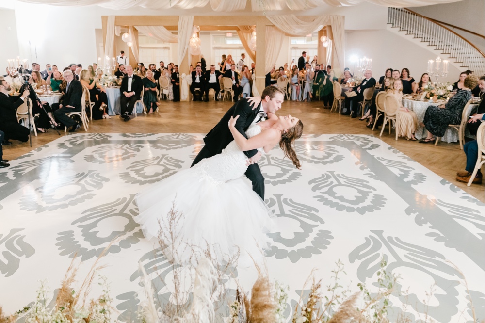 Bride and groom do a dip during their first dance at a luxury ballroom at a winery in New Jersey