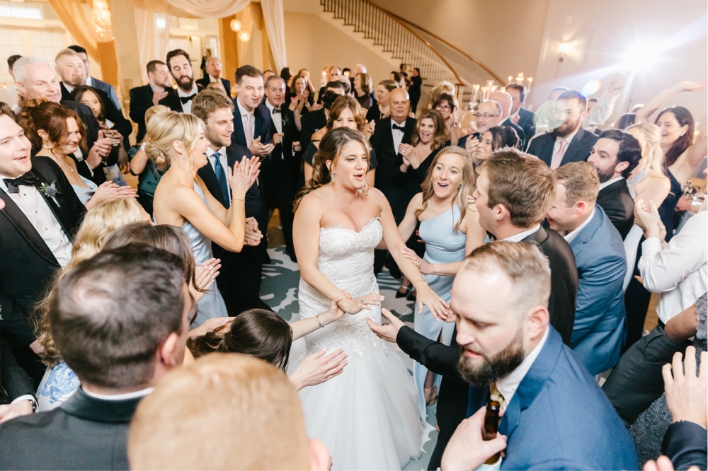 Bride and groom dance with their wedding guests and a luxury ballroom reception