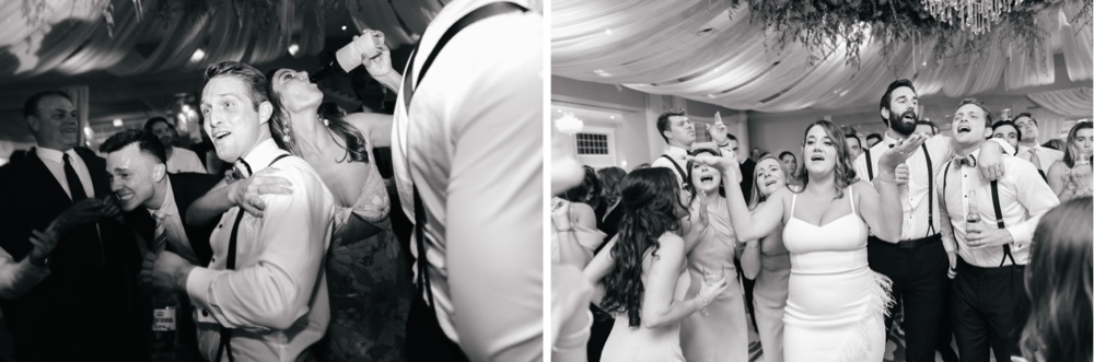 Bride and groom celebrating on the dance floor surrounded by their wedding guests