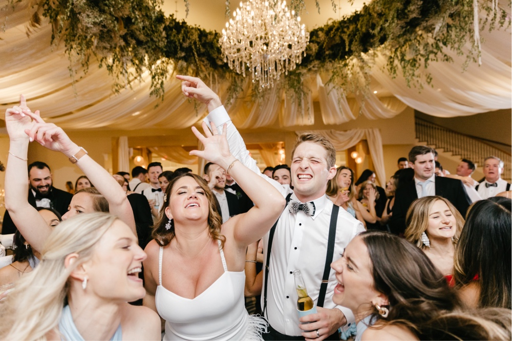 Bride and groom partying on the dance floor at their spring ballroom wedding reception
