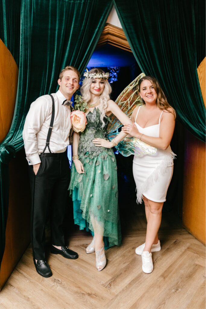 Bride and groom with fairy greeter on their enchanting winery wedding day