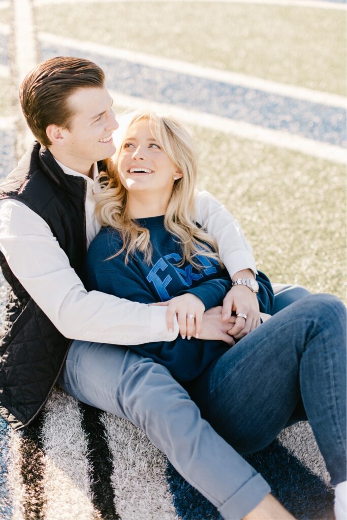 Couple smiling at golden hour during their football inspired engagement session near Philadelphia