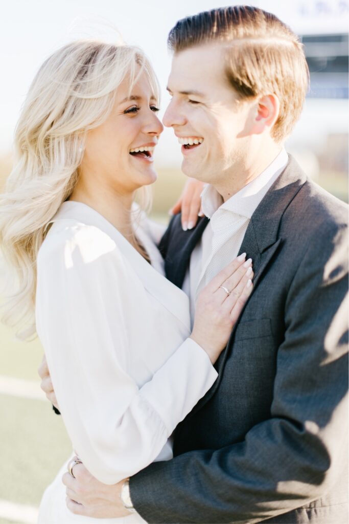 Couple laughing at golden hour during a vintage inspired engagement shoot near Philadelphia