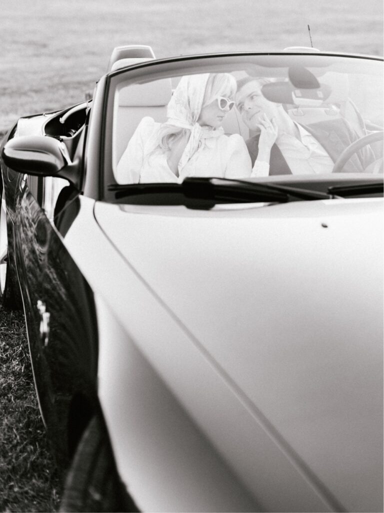 Couple sitting in a timeless convertible during a vintage inspired engagement session near Philadelphia