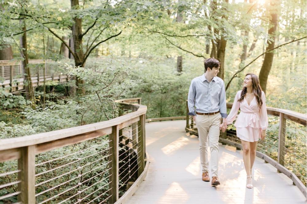 Couple walking among the trees during a timeless spring engagement session by Emily Wren Photography