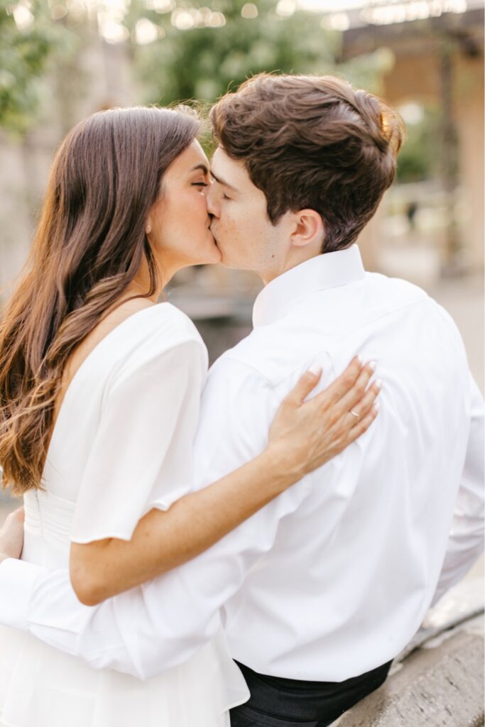 Couple kissing during golden hour at an engagement shoot at Longwood Gardens
