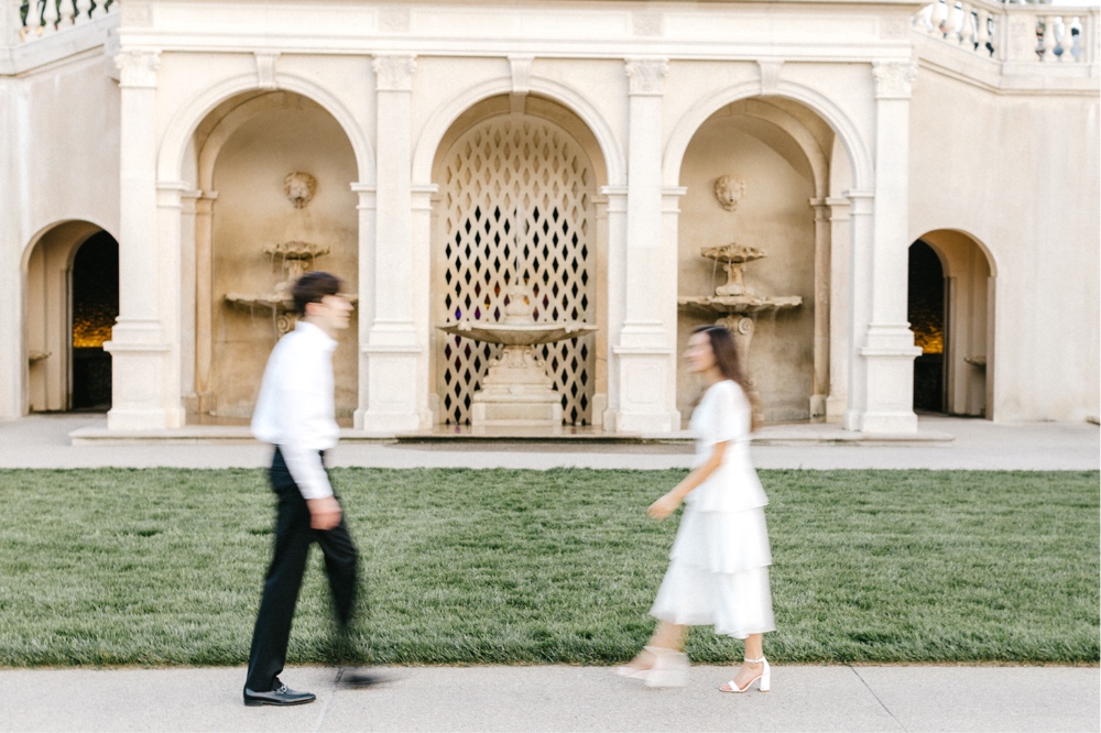 Couple walking in front of classic arches at Longwood Gardens in Pennsylvania