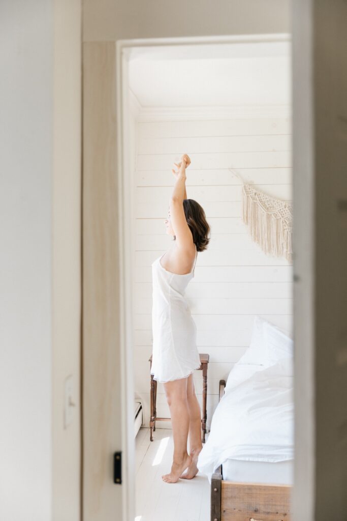 Bride stretching before getting ready for a boutique destination wedding in upstate New York
