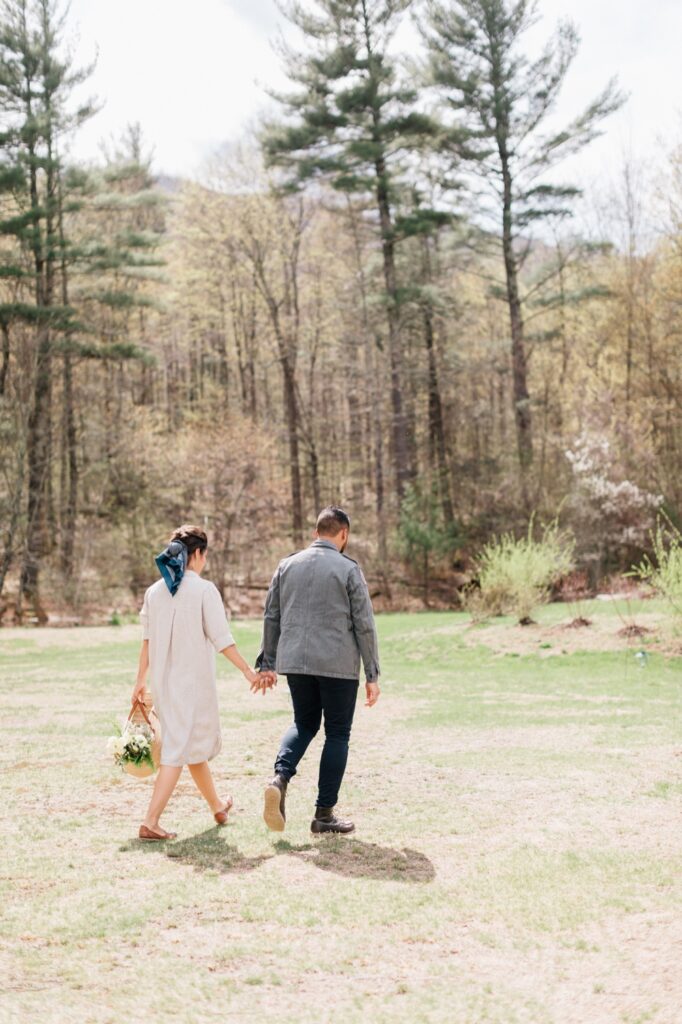 Couple holding hands on their sunny wedding day in upstate NY