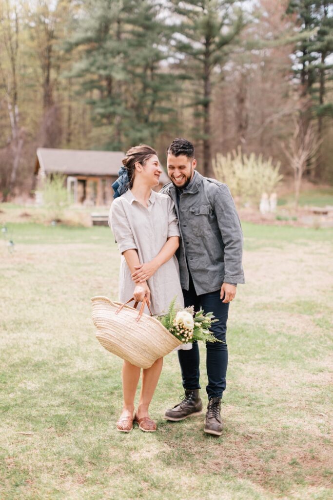 Couple laughing while foraging for greenery on the grounds of Foxfire Mountain House