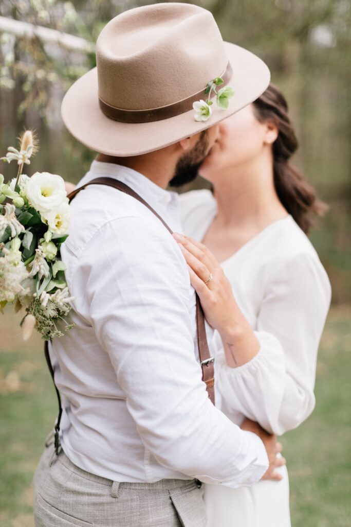 Newlyweds first kiss at a intimate outdoor wedding in upstate New York by Emily Wren Photography