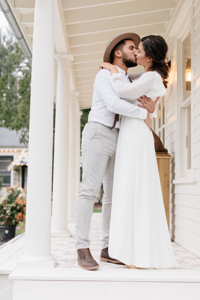 Bride and groom kissing at their rustic destination wedding at Foxfire Mountain House by Emily Wren Photography