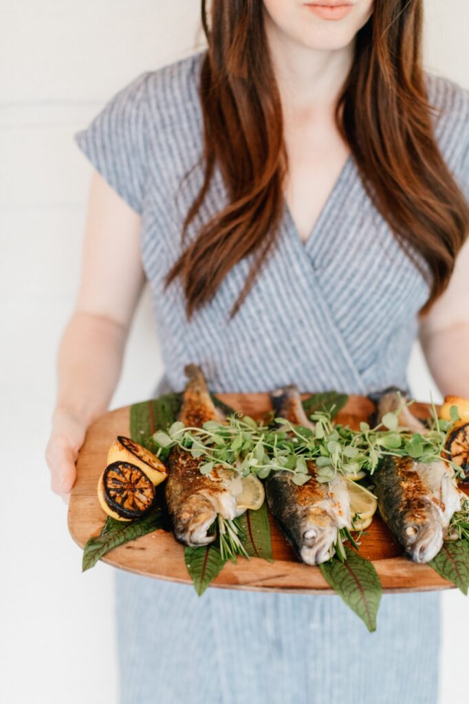 Whole fishes as part of a wedding dinner menu at a boutique hotel in upstate New York by Emily Wren Photography