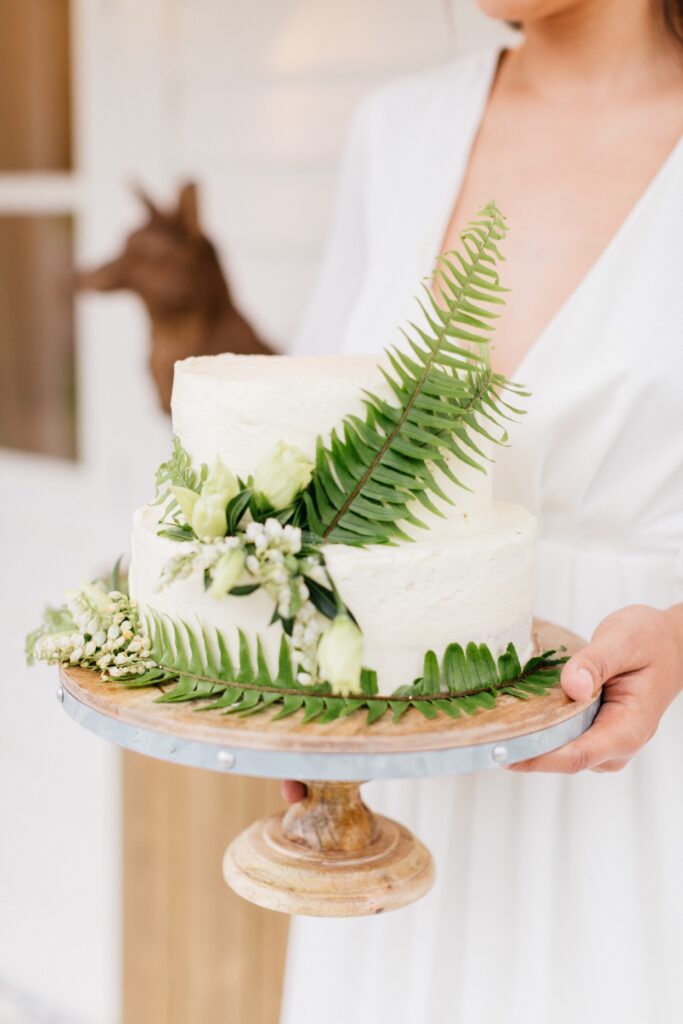 Rustic wedding cake with ferns and greenery for a romantic boutique hotel wedding by Emily Wren Photography