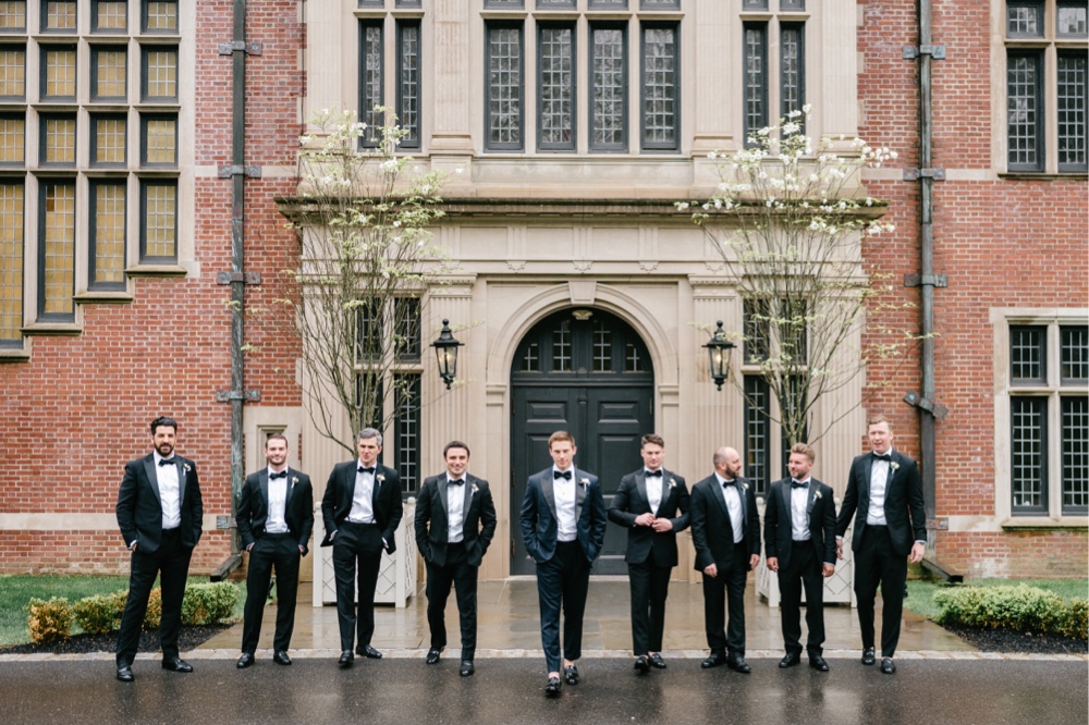 Groom and groomsmen walking on a rainy spring wedding day in New Jersey