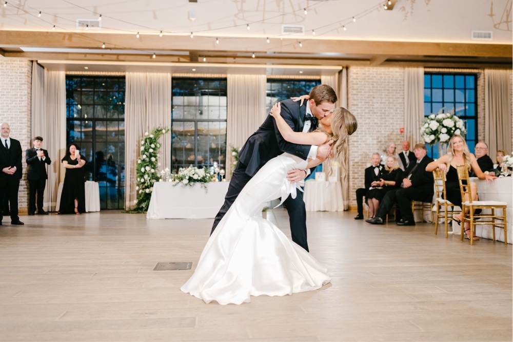 Newlyweds kiss during their first dance at an intimate wedding reception in NJ