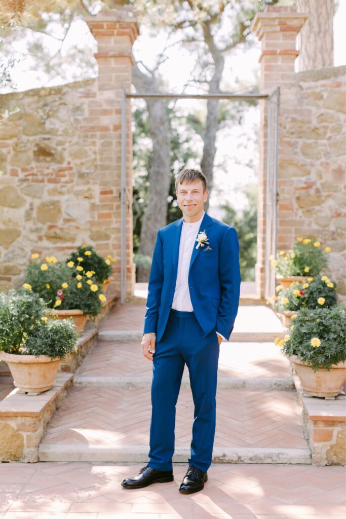 Groom in a blue suit before a summer destination wedding in Tuscany