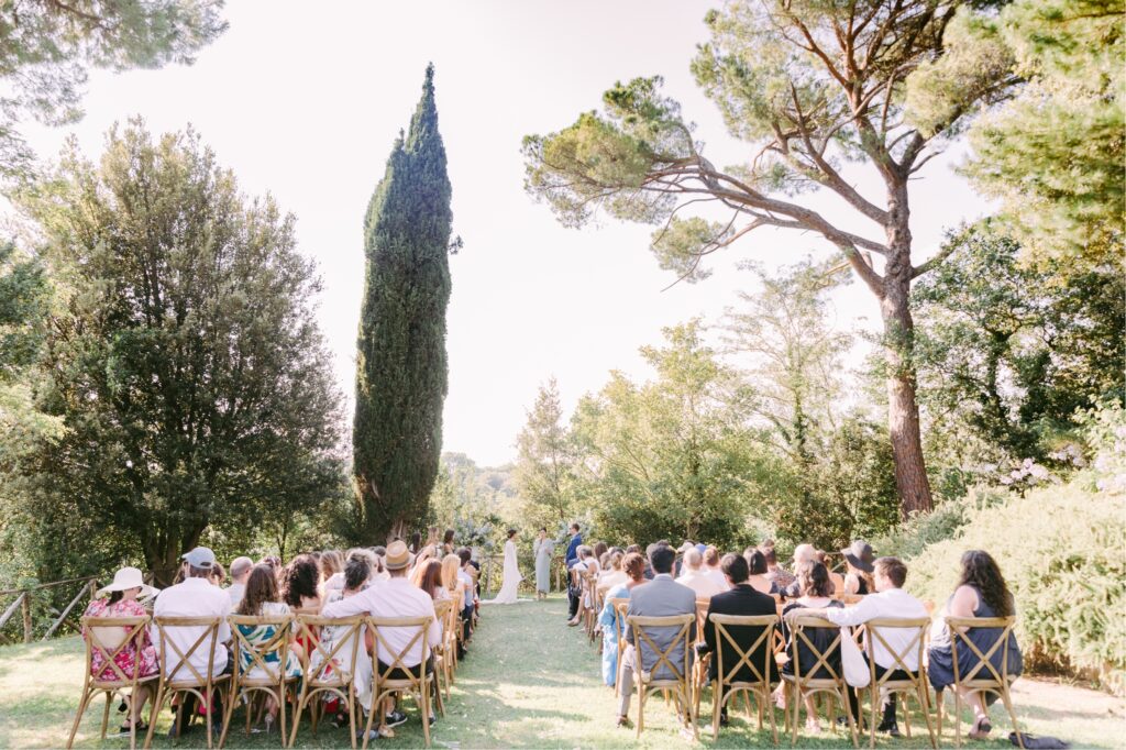 Guests watching a wedding ceremony at the Borgo Estate in Tuscany