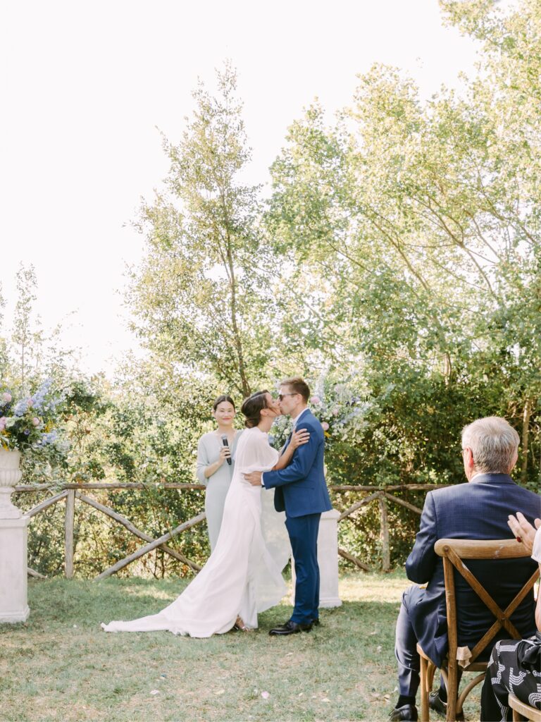 Newlyweds share their first kiss at a destination wedding in Italy