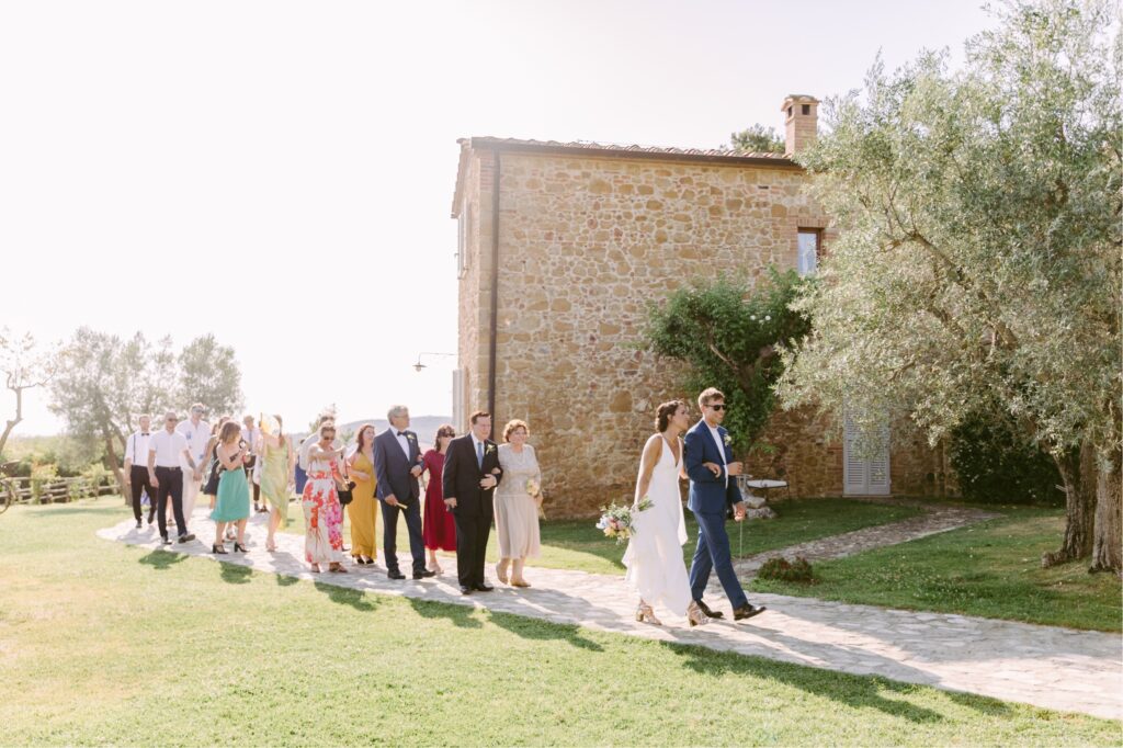 Guests walking to cocktail hour at the Borgo Sant'Ambrogio estate in Tuscany