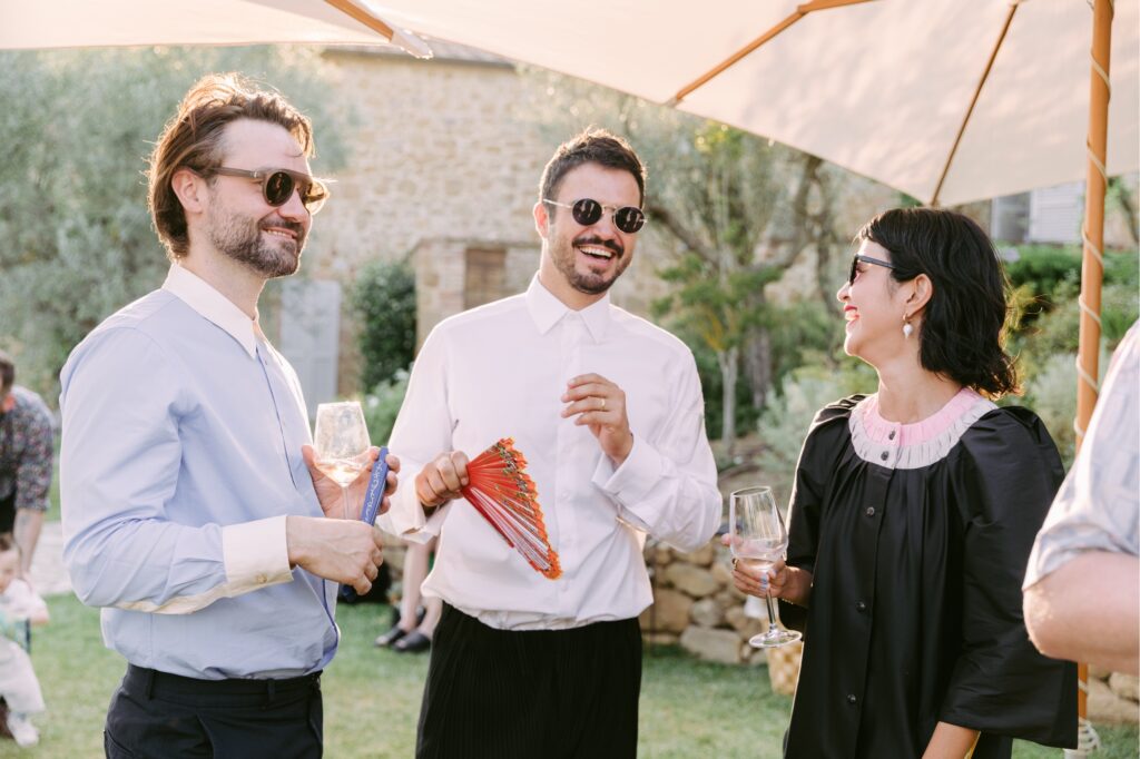 Guests laughing during cocktail hour at an italian destination wedding by Emily Wren Photography