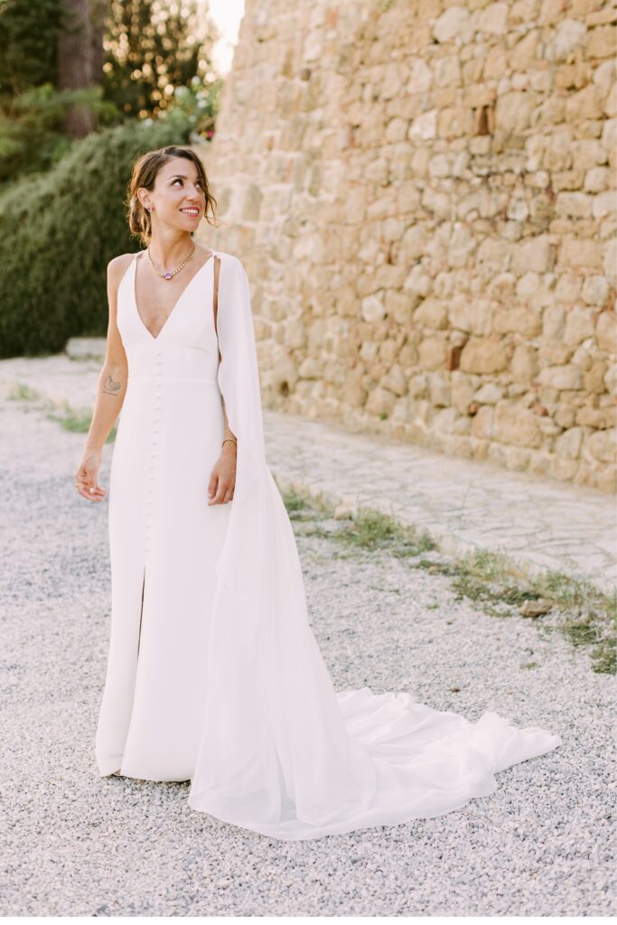 Bride with a chiffon wedding cape at an estate wedding in Italy