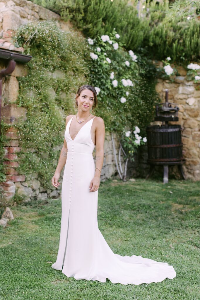 Bride in a historic italian courtyard at a destination wedding in Tuscany