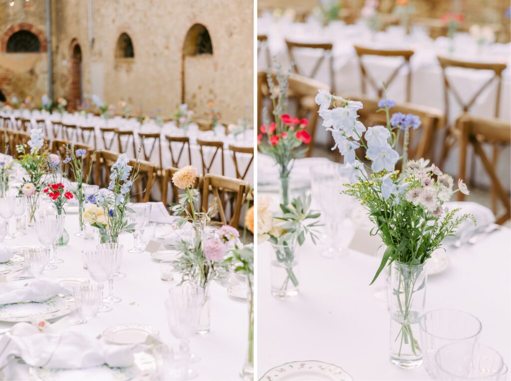 Wildflowers in bud vases at a romantic outdoor reception at a destination wedding in Tuscany