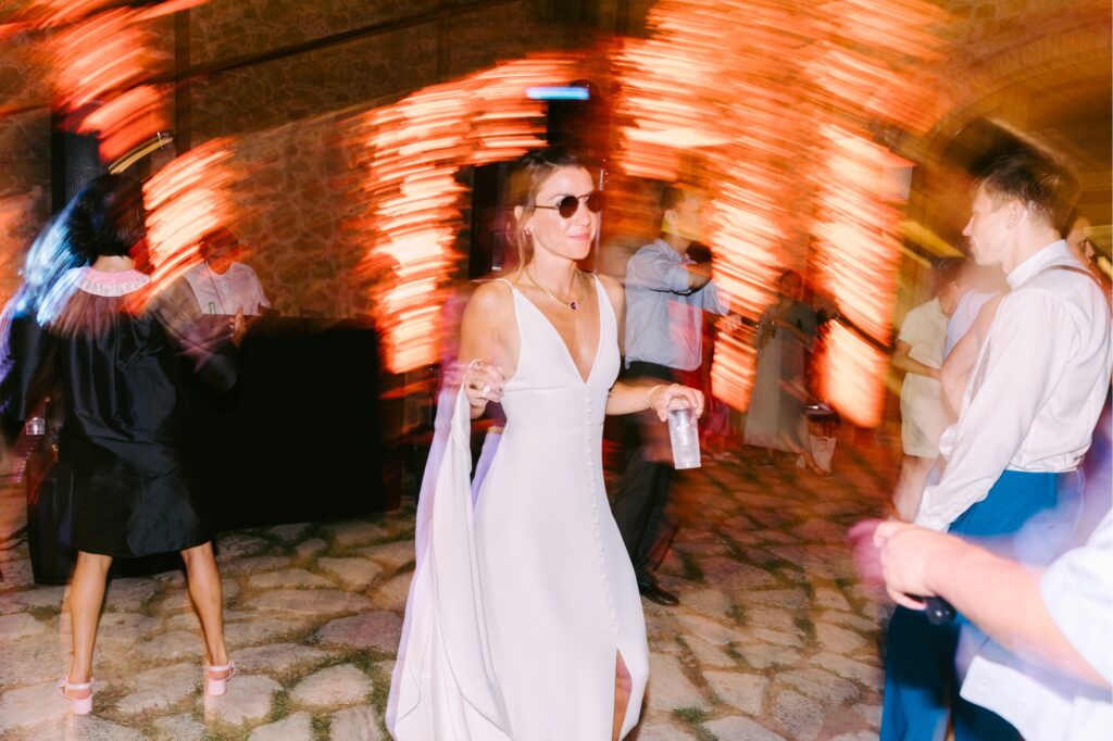 Bride dancing at her wedding reception at an estate in Tuscany by Emily Wren Photography