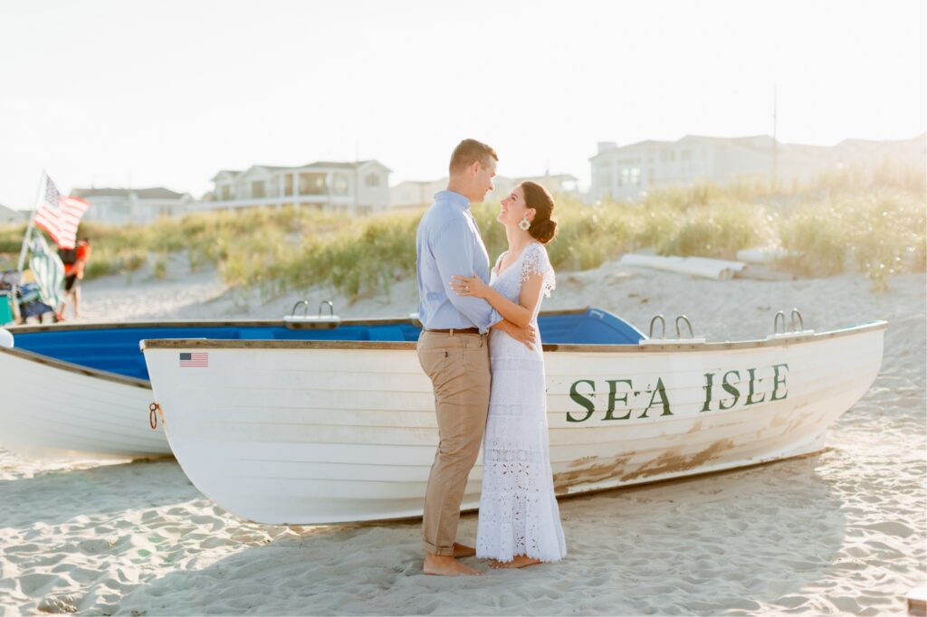 Couple in front of boats on the beach in Sea Isle, New Jersey