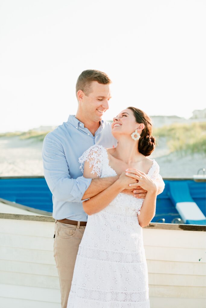 Couple smiling at each other during a beach engagement session at the Jersey Shore