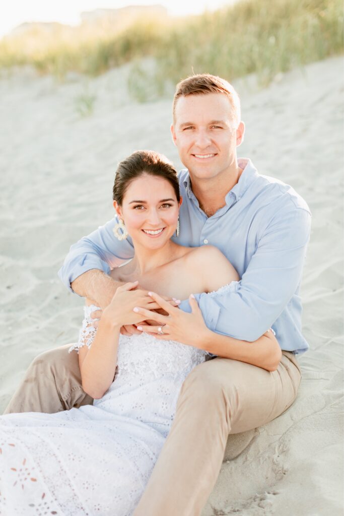 In love couple smiling during a beach engagement session in Sea Isle, New Jersey