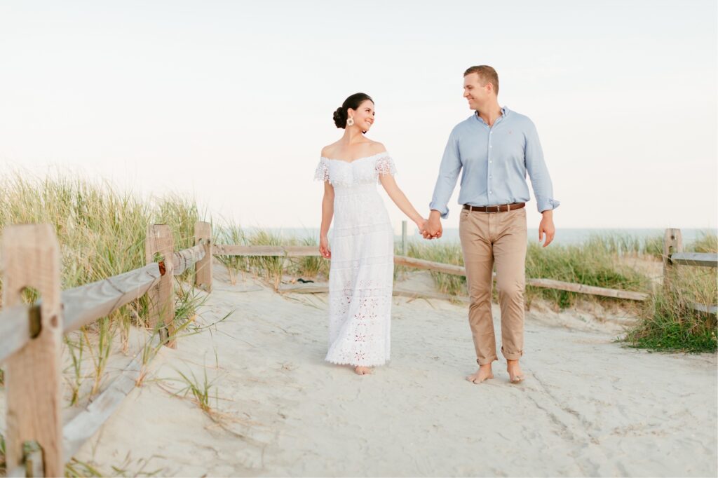 Couple walking along the sand dunes during a Jersey Shore engagement session