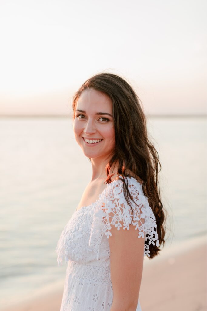 Bride to be smiling at sunset on the beach at the Jersey Shore