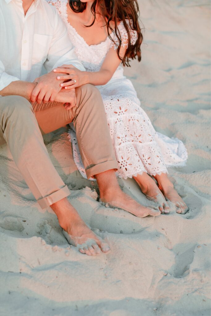 Feet buried in the sand during a beach engagement shoot on a summer day in NJ