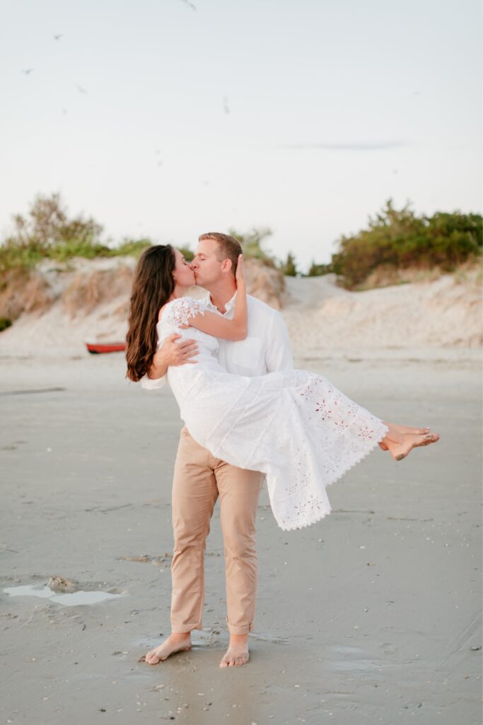Couple kissing as the sunsets at the Jersey Shore for a beach engagement shoot
