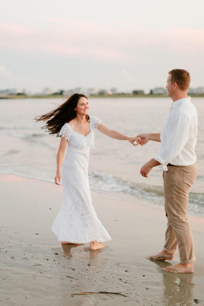 Laughing couple during a sunset engagement session at the Jersey Shore