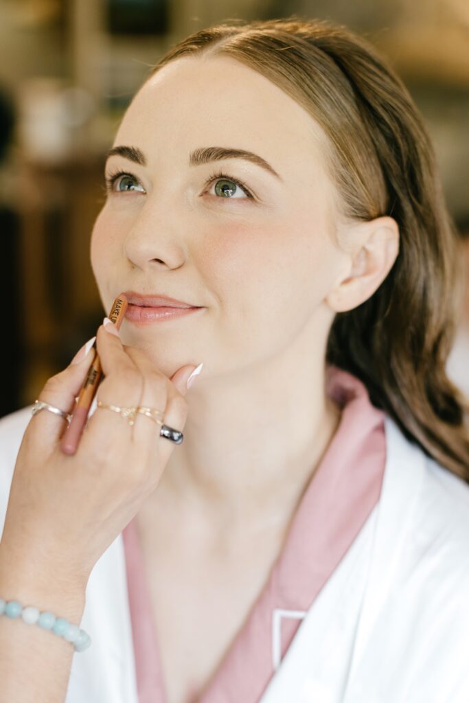 a bride getting her makeup done for her Spring wedding in Glen Mills, Pennsylvania