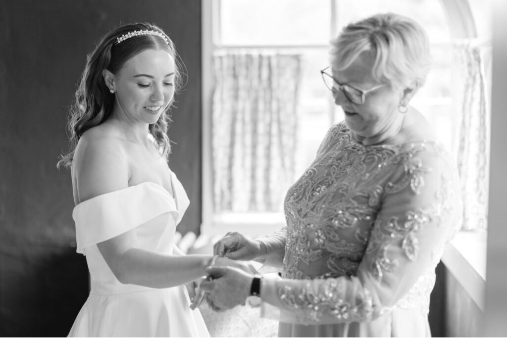 a bride getting ready with her mother by Emily Wren Photography