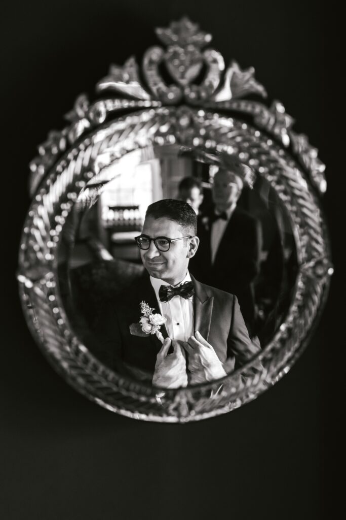 portrait of a groom in a vintage mirror