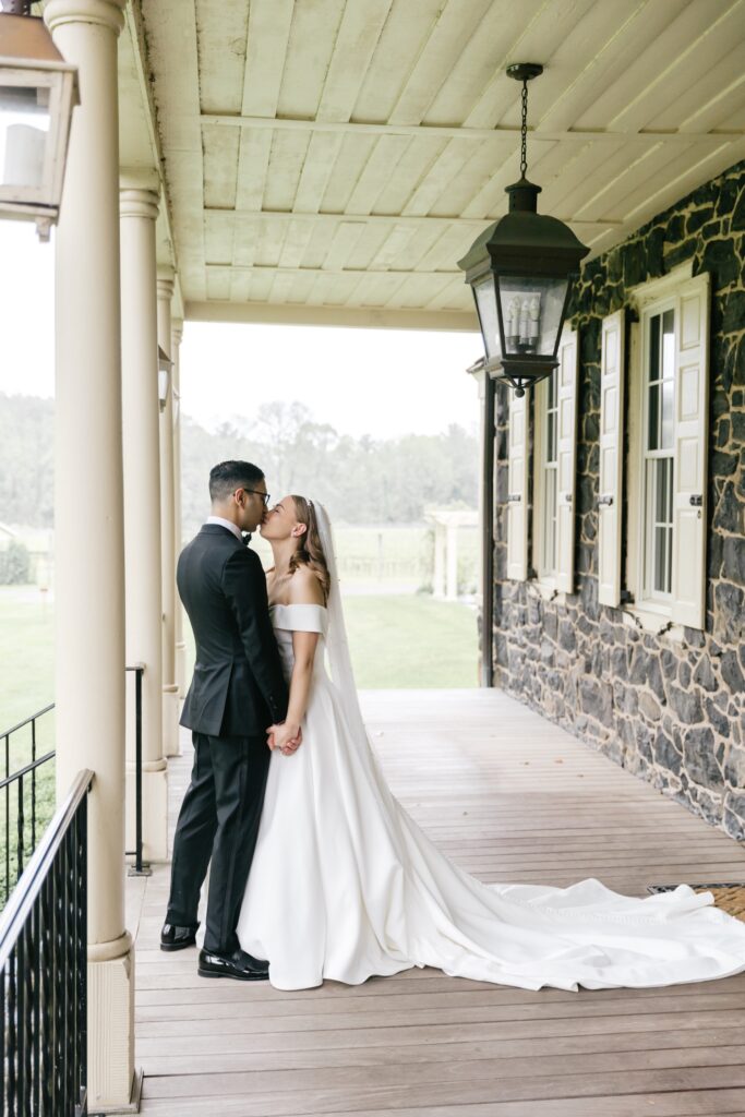 bride and groom kissing during their first look in Glen Mills, Pennsylvania
