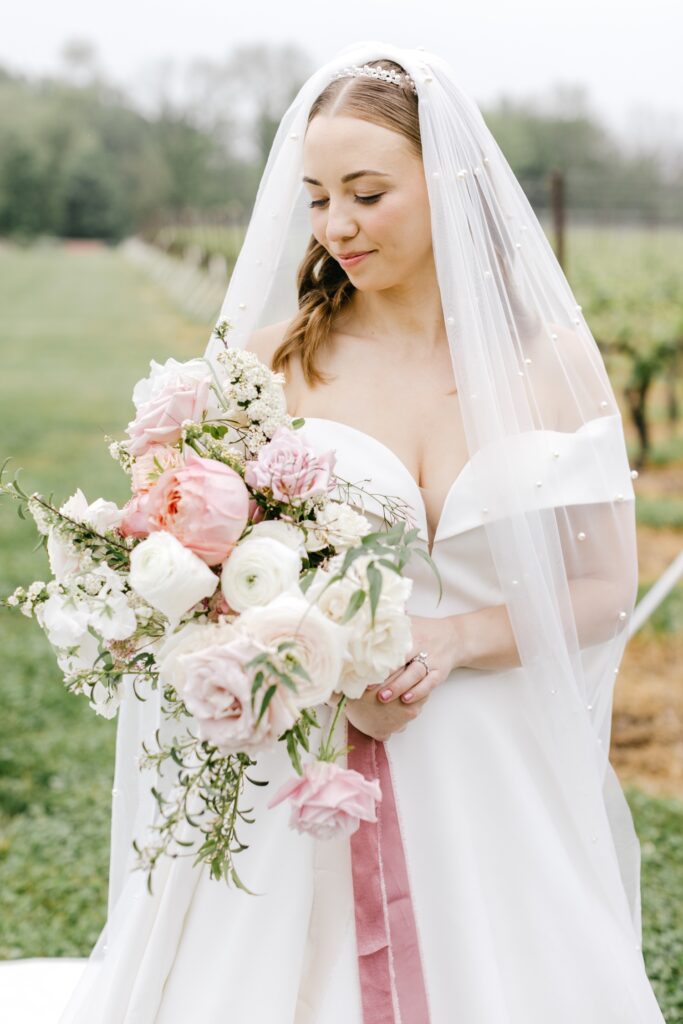 bride with her wedding bouquet with pink and white flowers