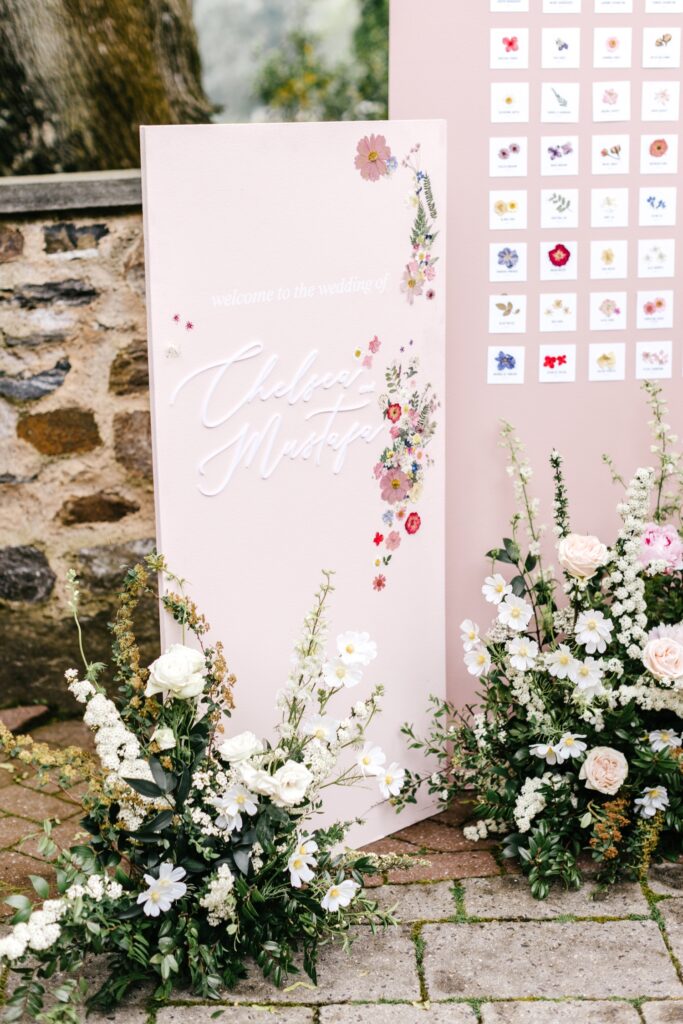 pink flower wall seating chart for a Pennsylvania garden wedding