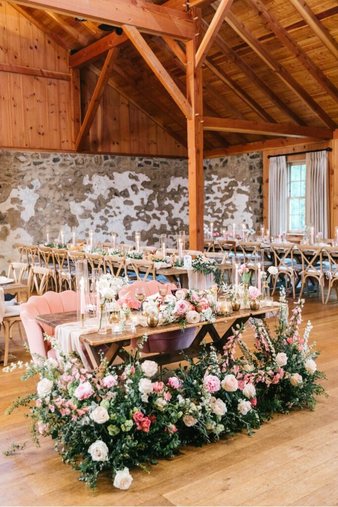 sweetheart table for a Spring flower themed wedding including blush pink, coral and white floral details