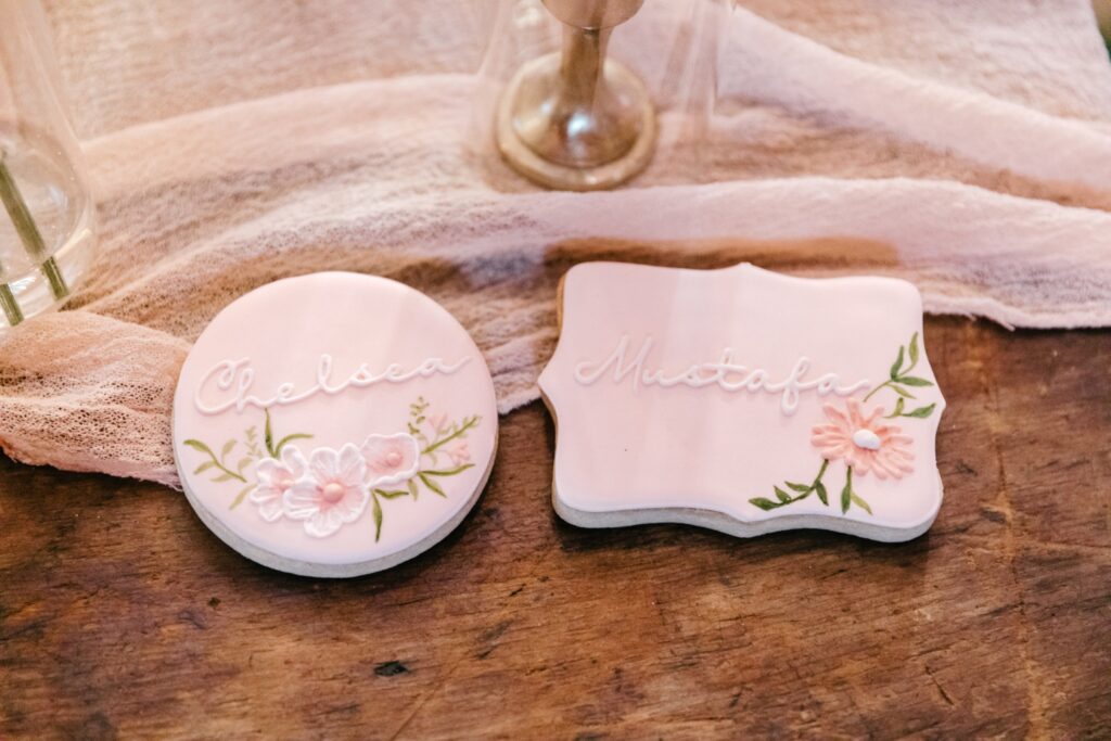 custom pink floral cookies with the bride and grooms names
