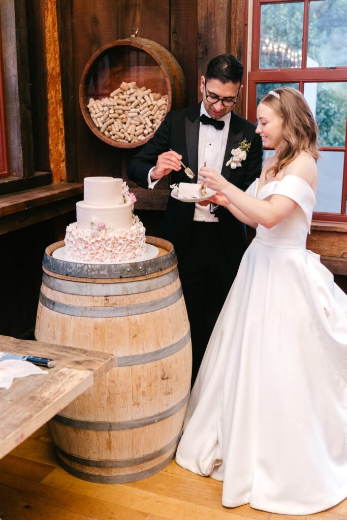 bride and groom tasting their wedding cake for the first time