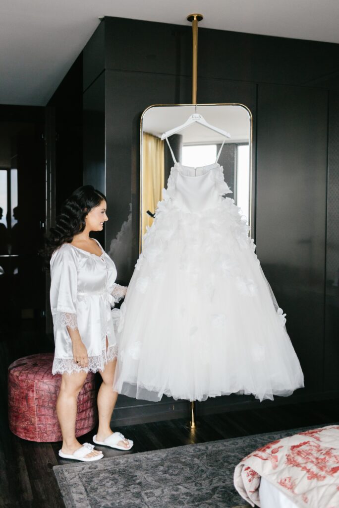 A bride admiring her dress before her Spring wedding day in Philadelphia
