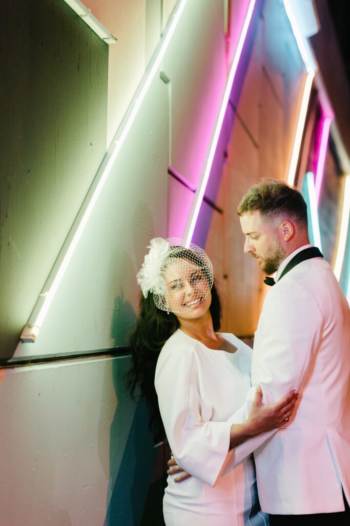 Bride and Groom under neon lights in Philadelphia