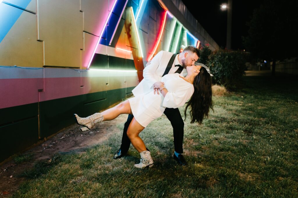 Bride and Groom kissing under neon lights at Cescaphe's Franklin's View