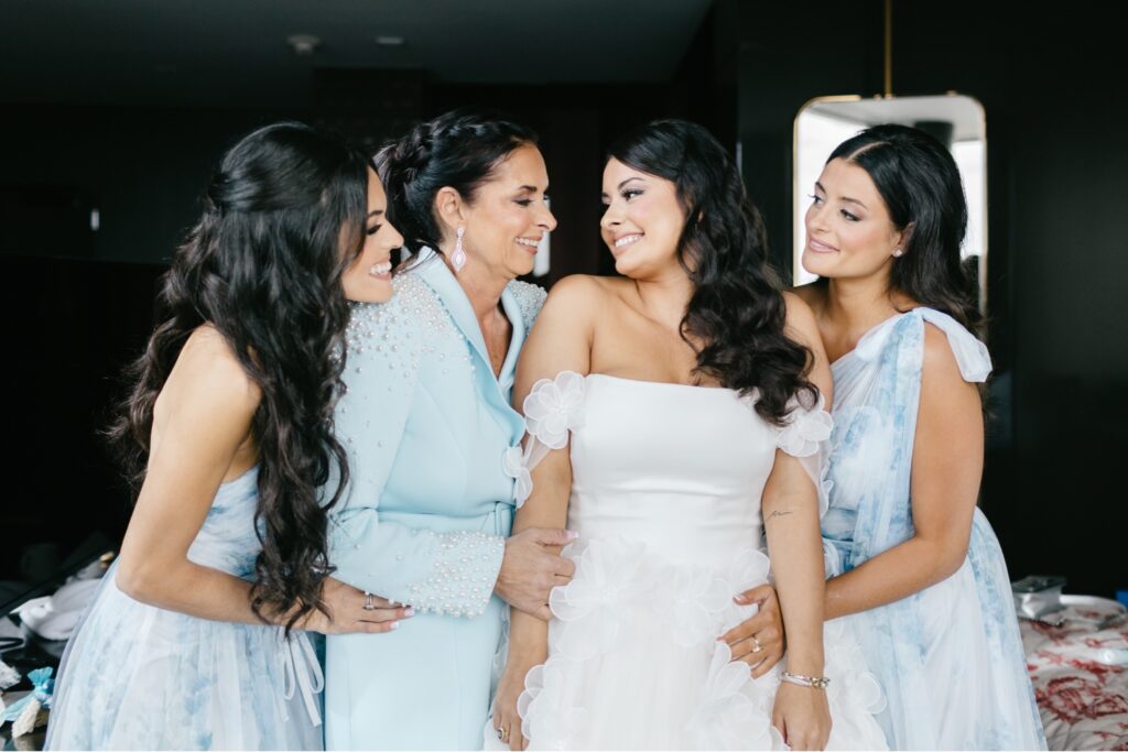 a Bride and her bridesmaid while getting ready for her Cescaphe wedding